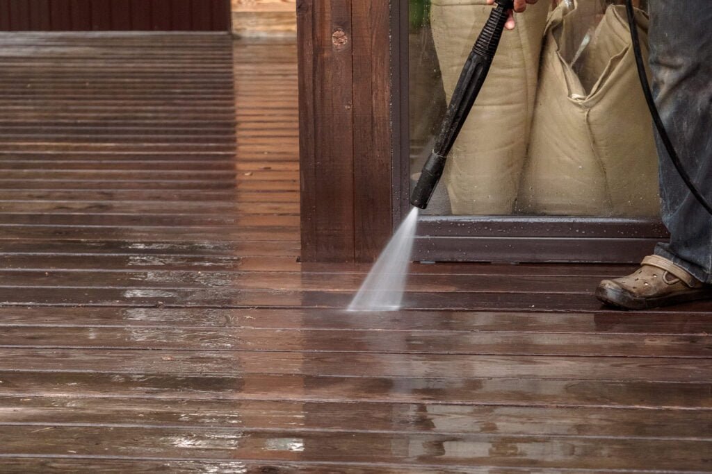 clean wood deck with pressure washer